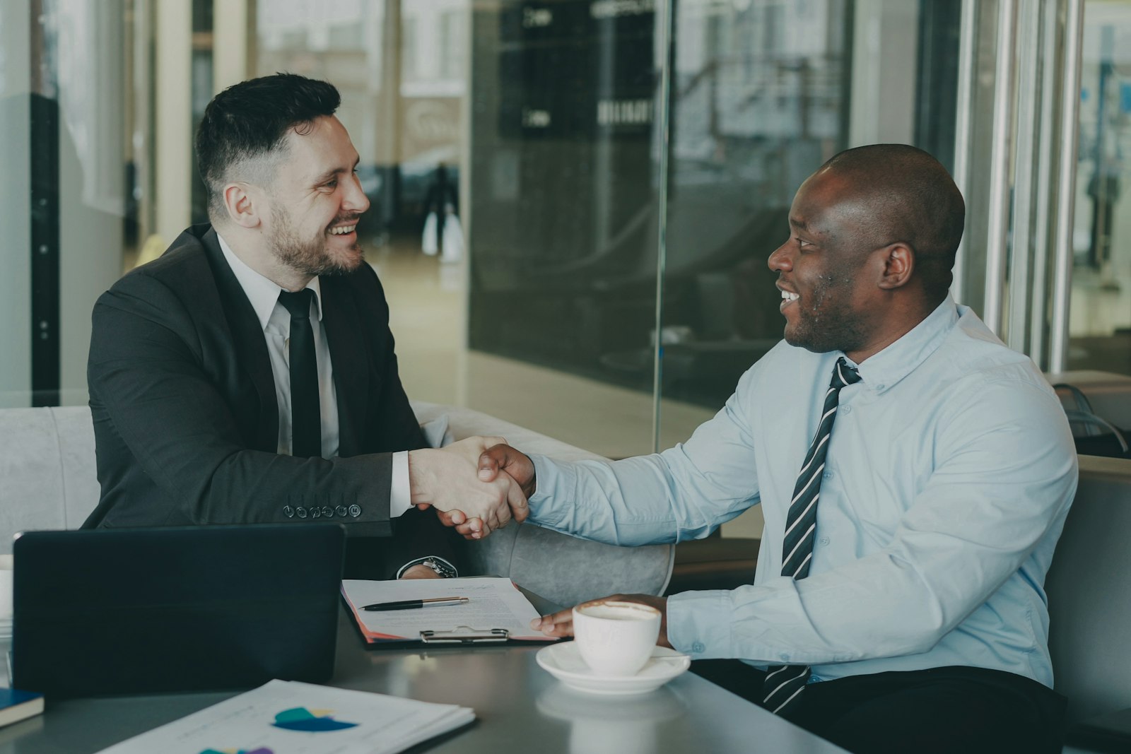 Two business partners shaking hands to agree a brand partnership